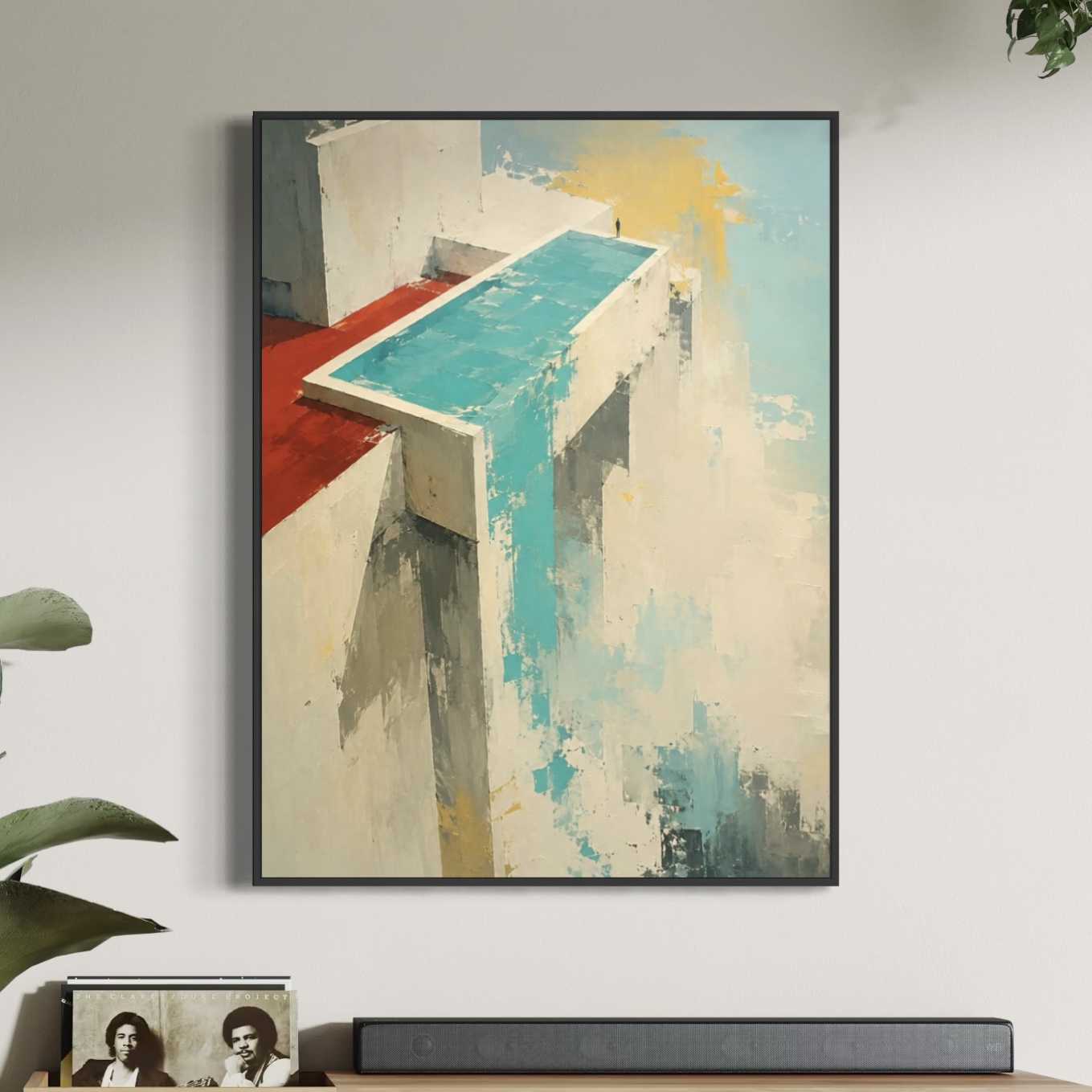 Tableau Vertige Suspendu encadré dans un salon contemporain avec architecture abstraite turquoise, beige et rouge au-dessus d’un meuble moderne.